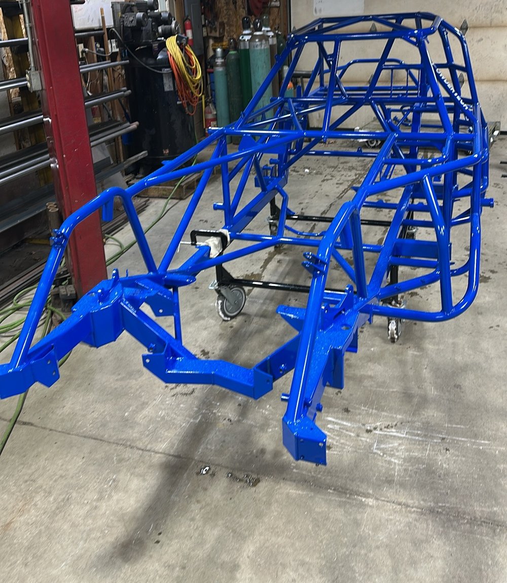 A freshly powder-coated blue Manimal chassis in the shop
